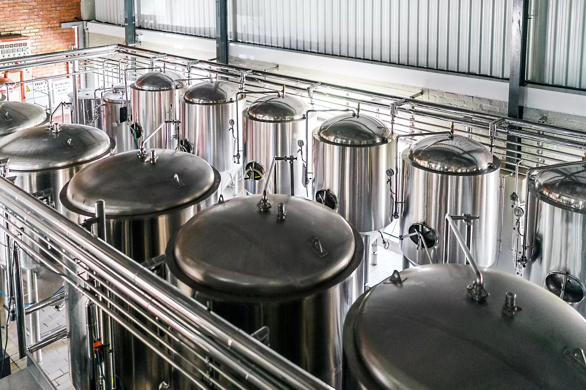Metallische Fässer in einer Brauerei Blick auf Stahlbehälter in einer Fabrik Bier wird in riesigen Lagertanks in der Industrie gelagert